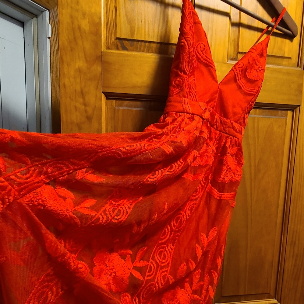 Beautiful red maxi dress. Never worn, tags attached. Lined until the mid thigh.